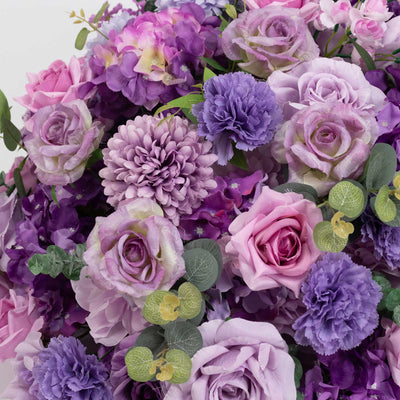 Purple and pink floral bouquet with roses, hydrangeas, and carnations