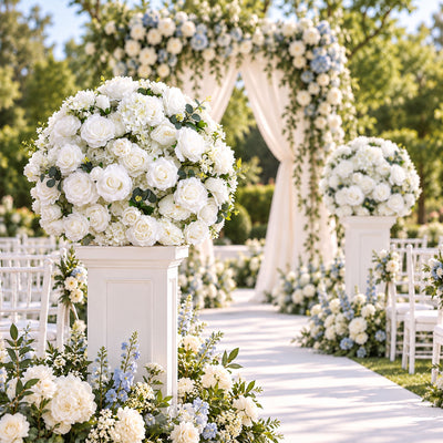 White floral wedding aisle with elegant arch and pedestal arrangements
