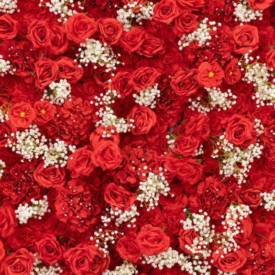 Vibrant red roses and white flowers in a lush floral arrangement.
