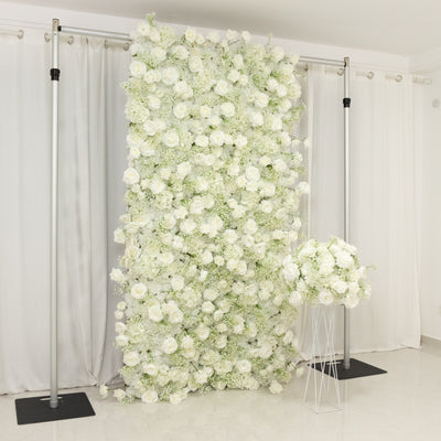 White floral backdrop with roses and greenery for events and photo shoots.