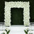White floral archway for weddings or events on a green backdrop.