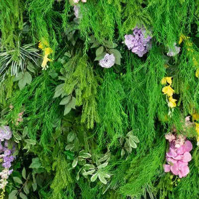 Lush vertical garden wall with green foliage and pastel flowers