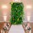 Elegant floral wedding arch with lush greenery, candles, and white aisle runner