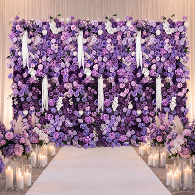 Lavender floral wedding backdrop with candles and white aisle runner