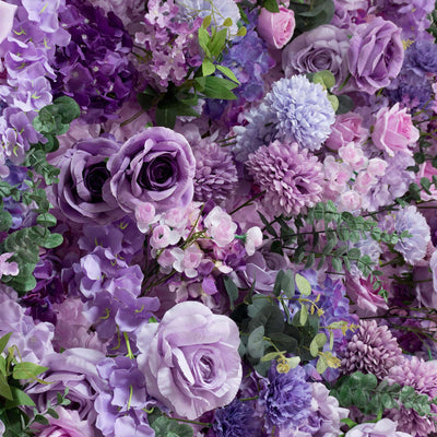 Purple and pink floral arrangement with roses, hydrangeas, and greenery
