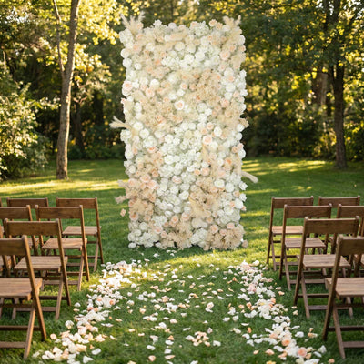 Outdoor wedding ceremony with white floral arch and wooden chairs on grass