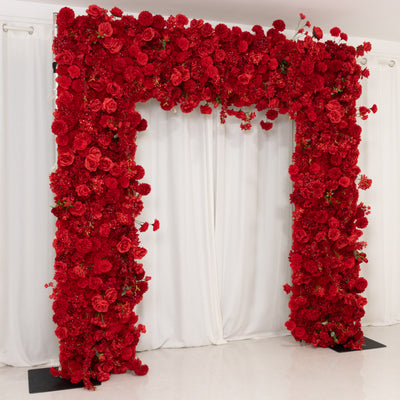 Red floral archway backdrop for events and celebrations.