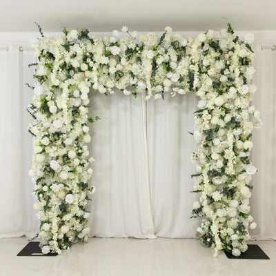White floral arch decor with greenery for events and weddings.