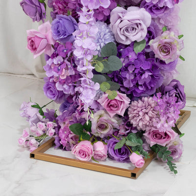 Purple and pink artificial rose floral arrangement in gold square vase