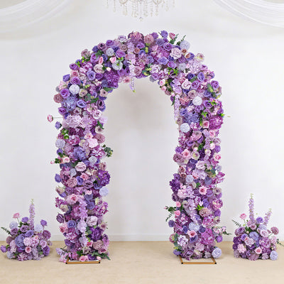 Purple floral arch wedding backdrop with matching flower arrangements