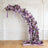 Purple floral arch with various blooms in an elegant design.