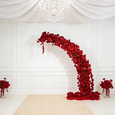 Red floral arch with arrangements, perfect for weddings and events