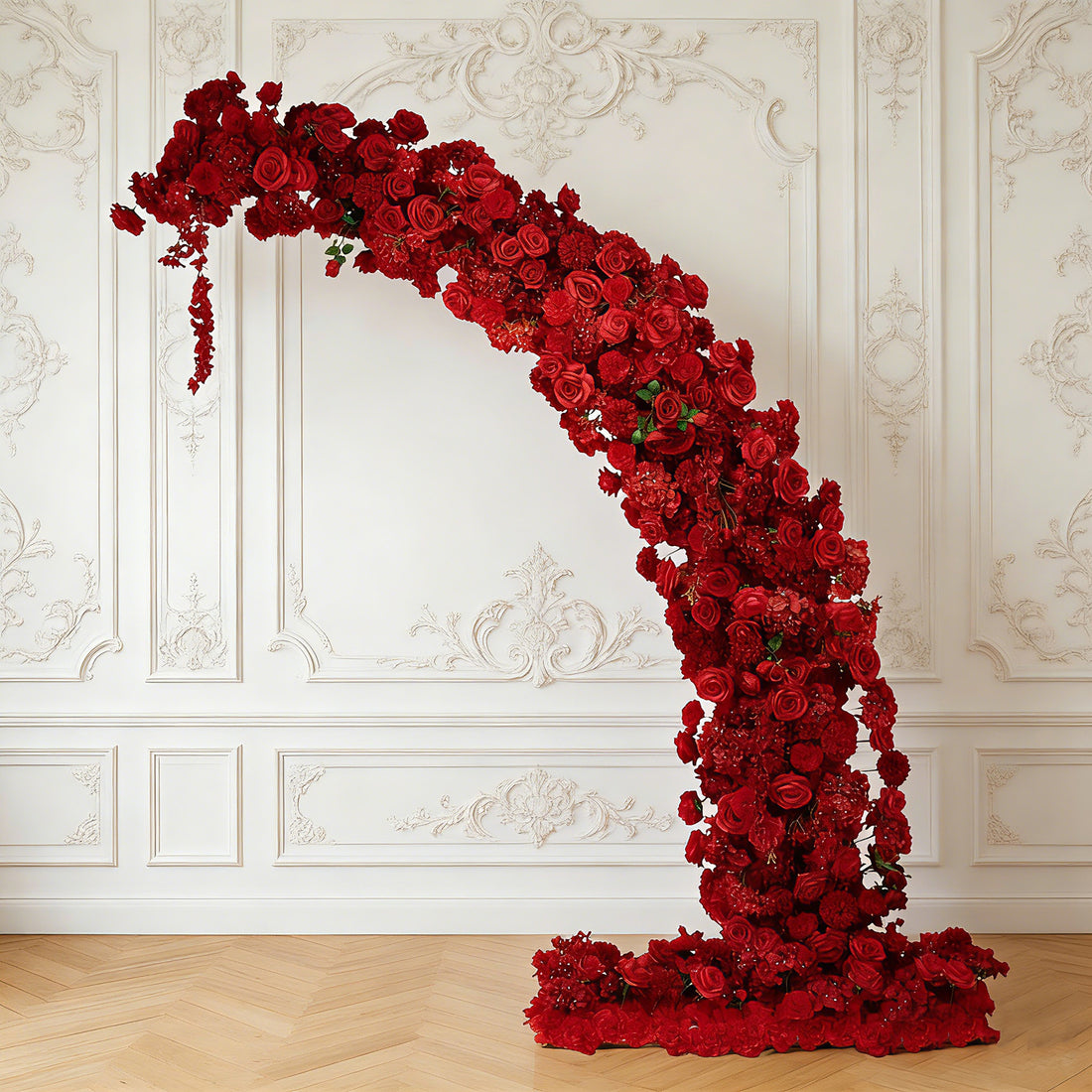 Red floral arch decor with intricate rose arrangements.