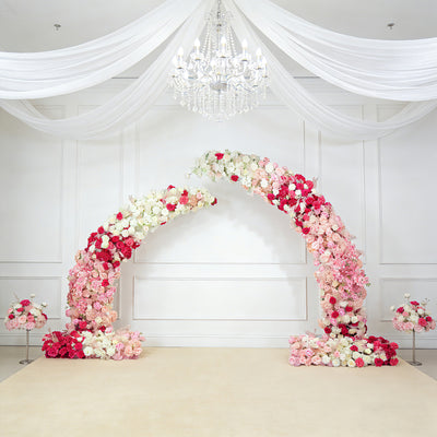 Floral arch arrangement in pink and white with chandelier backdrop