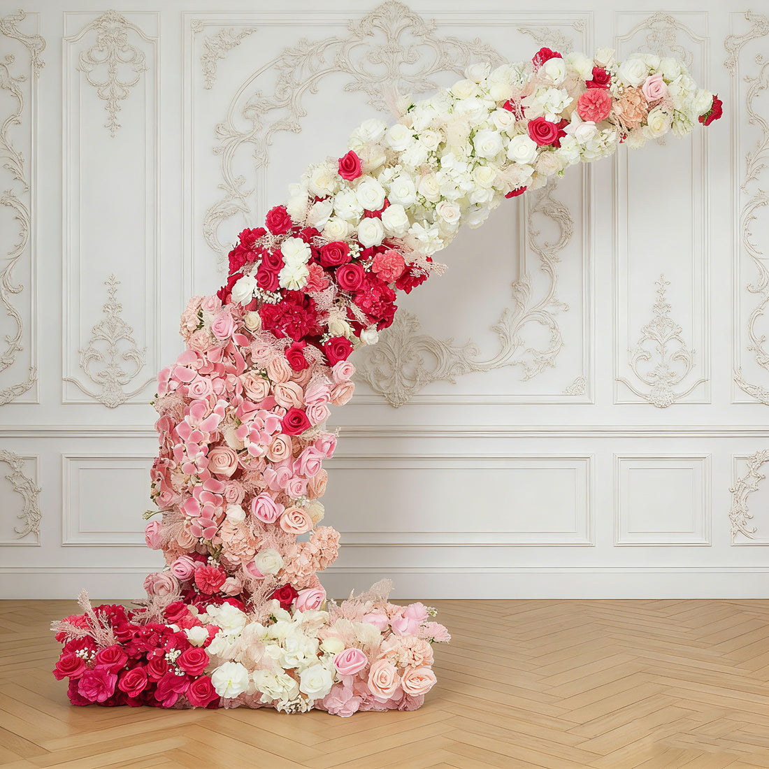 Floral arrangement in pink and white, elegantly curved against a decorative backdrop.