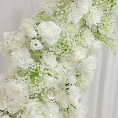 Elegant white floral arrangement with roses and hydrangeas on a soft backdrop