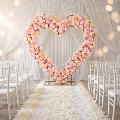 Pastel floral heart wedding arch with white aisle and chairs