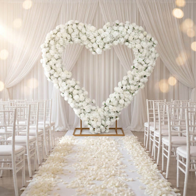 Elegant white floral heart wedding arch with aisle and chairs