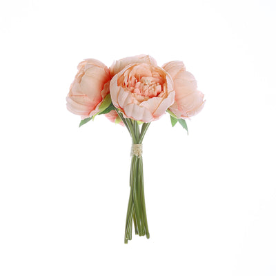 Peach artificial peony bouquet on a white background