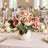 Elegant floral centerpiece on a candlelit wedding reception table
