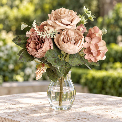 Artificial flower bouquet in glass vase on outdoor table