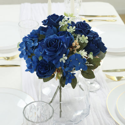 Blue rose floral arrangement in a clear vase on a dining table.