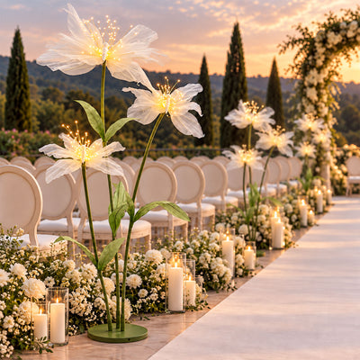 Elegant sunset wedding aisle with floral lights, candles, and white chairs