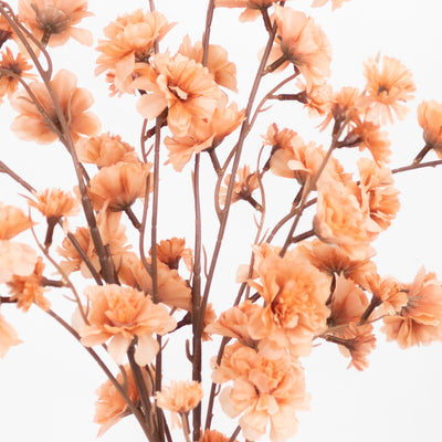 Peach artificial flowers bouquet on a white background