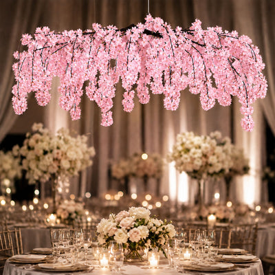Elegant wedding reception with pink cherry blossom chandelier and candlelit tables