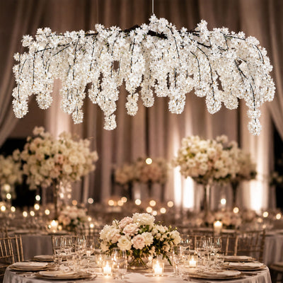 Elegant wedding reception with hanging white floral chandelier and candlelit tables