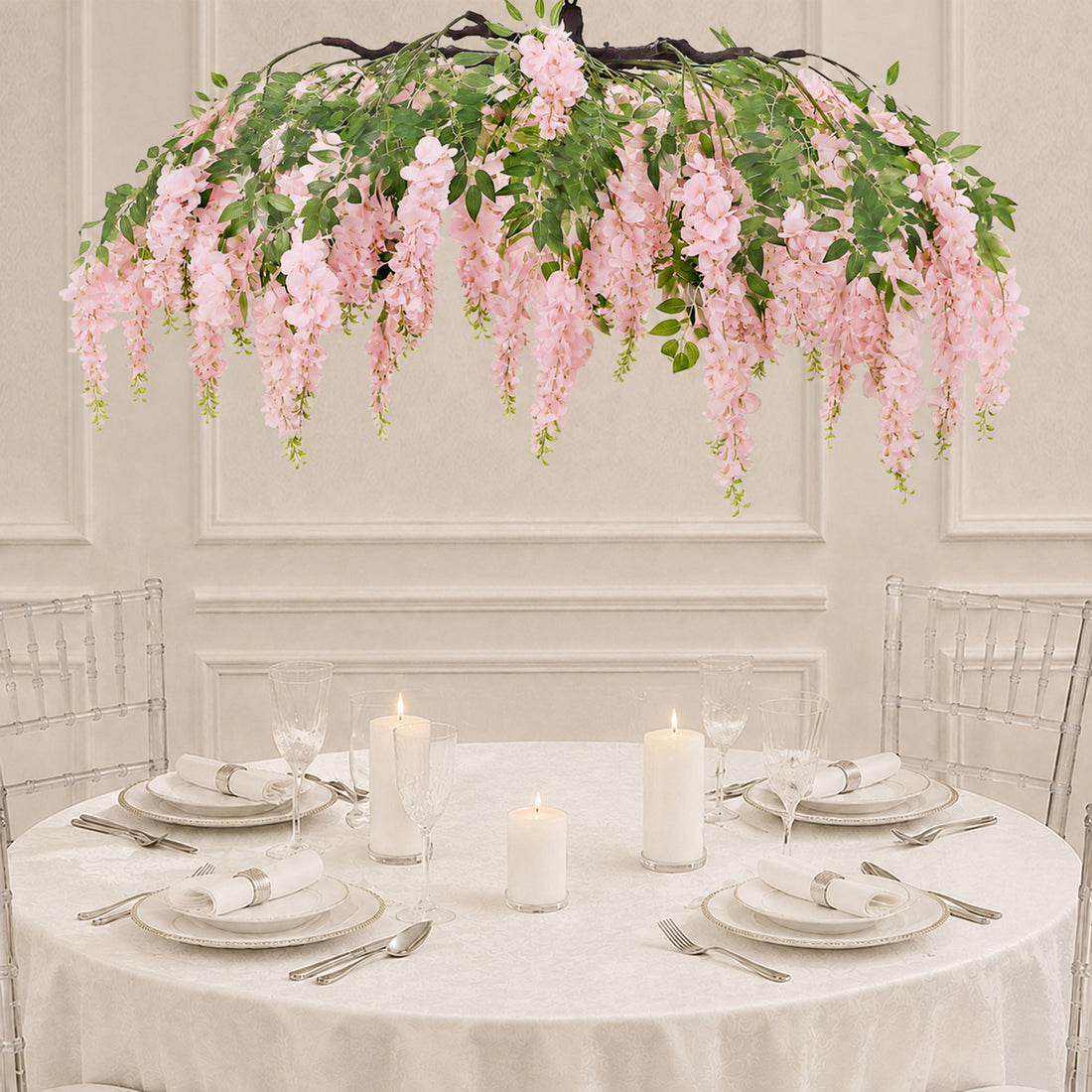 Elegant round table setting with pink floral hanging centerpiece and candles