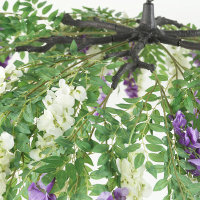 Artificial floral arrangement with green leaves and purple flowers.