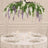Elegant white and purple floral wedding table centerpiece with candles