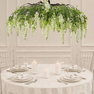 Elegant white wedding table with floral chandelier and clear chairs