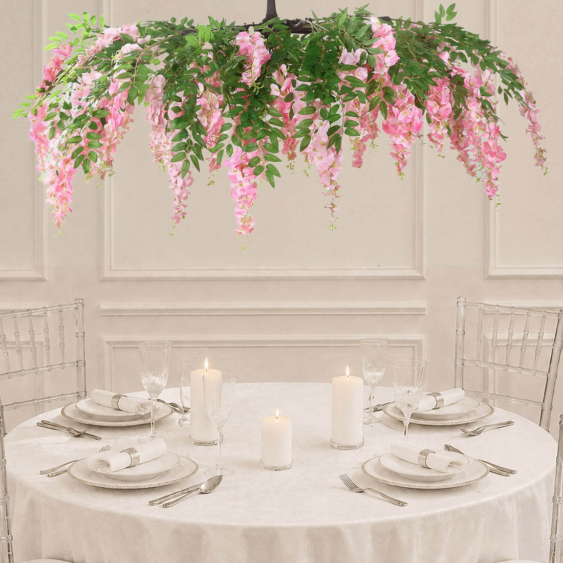 Elegant round banquet table with pink floral hanging centerpiece and candles