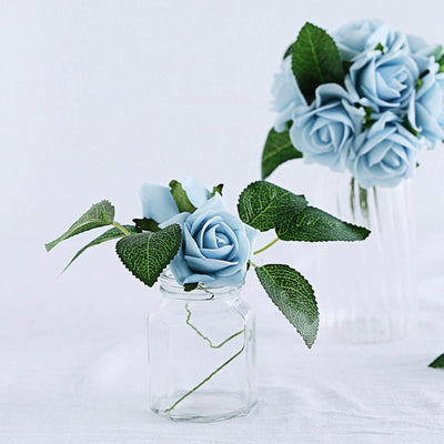 Blue artificial rose in a glass jar with leaves.