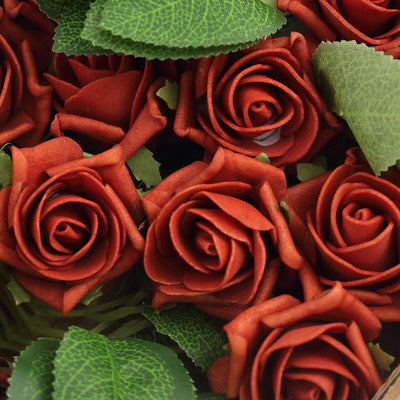 Artificial red roses with green leaves arranged beautifully.