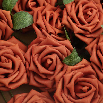 Rustic orange faux roses with green leaves arranged beautifully.