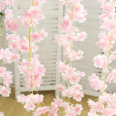 Pink floral garland decoration hanging on a screen backdrop.