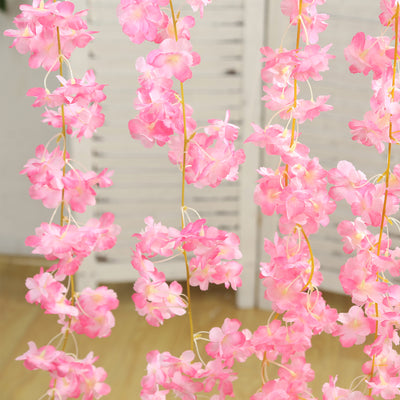 Pink flower garland decoration on a white background.
