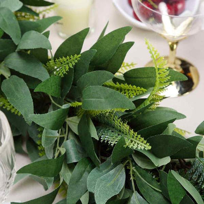 Artificial greenery garland with various leaf types for decor.