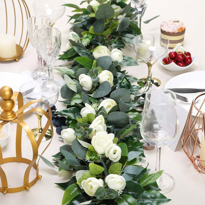 Elegant floral table centerpiece with greenery and white roses for dining decor.