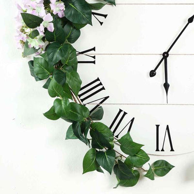 Clock with greenery and flowers on a white background