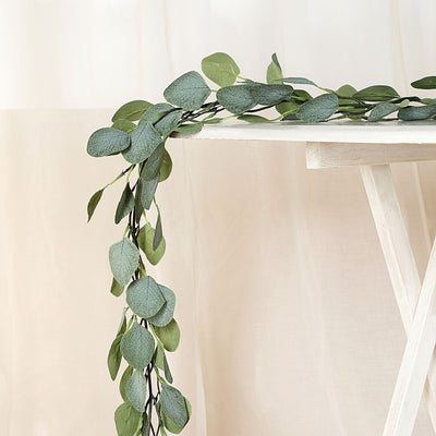 Lush green eucalyptus garland draping over a white table