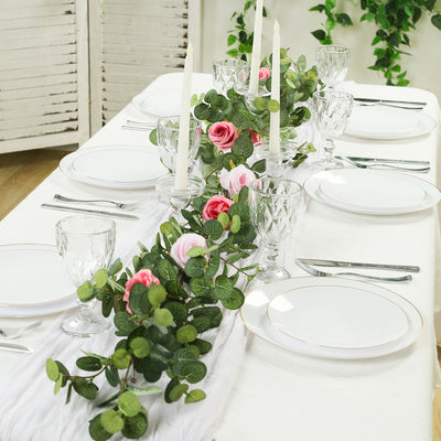 Elegant table setting with floral centerpiece and candles.
