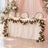 Elegant wedding reception table with pink drapery, candles, and floral garland
