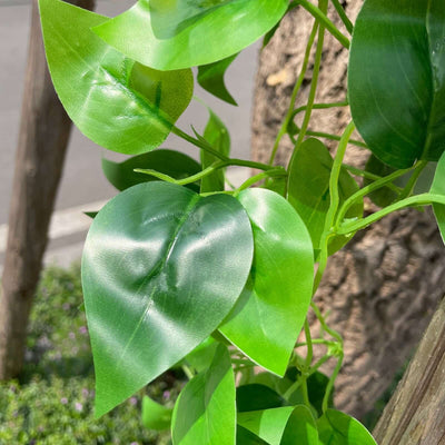 Artificial green leaf plant close-up showing vibrant foliage details.