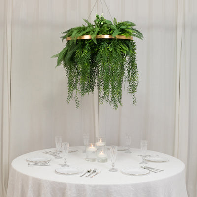 Hanging fern centerpiece above a beautifully set dining table.