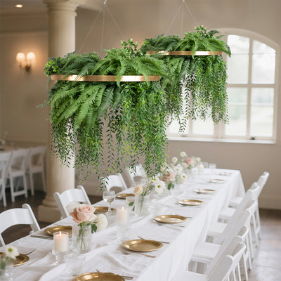 Hanging greenery decor for elegant event table setting with gold accents.