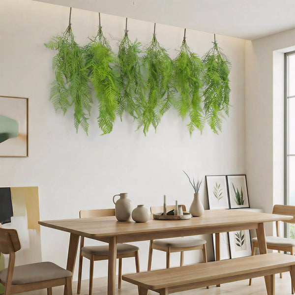 Modern dining room with hanging ferns, wooden table, and minimalist decor